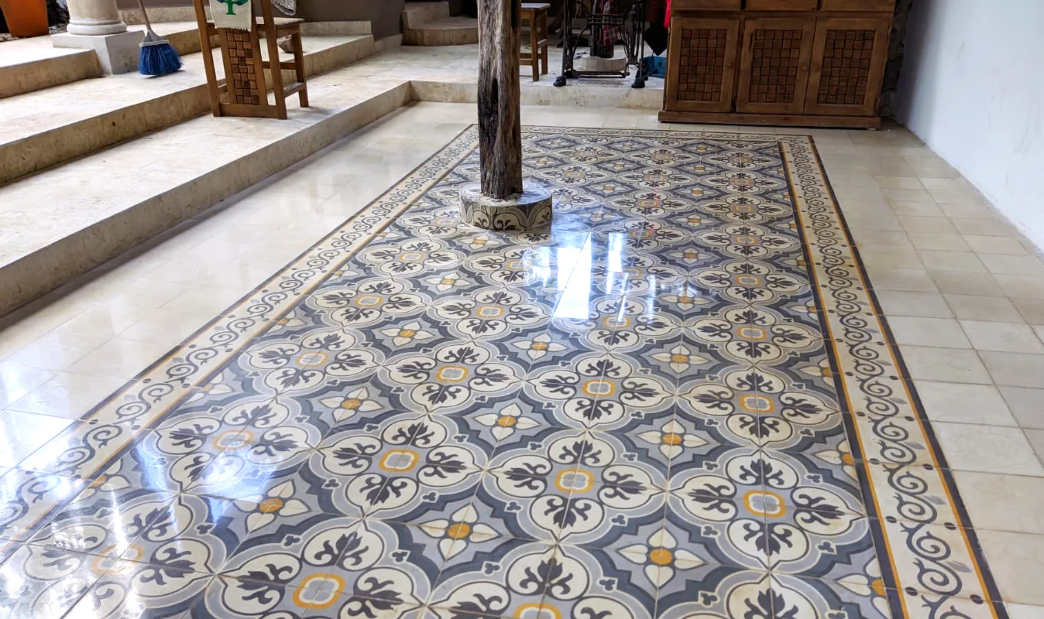 Handcrafted cement tile composition installed as a floor rug